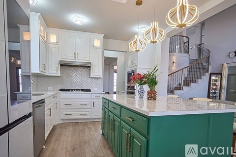 A kitchen with green cabinets and a stove top oven.