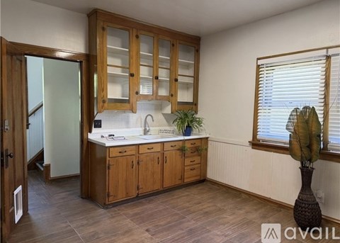 A kitchen with wooden cabinets and a white countertop.