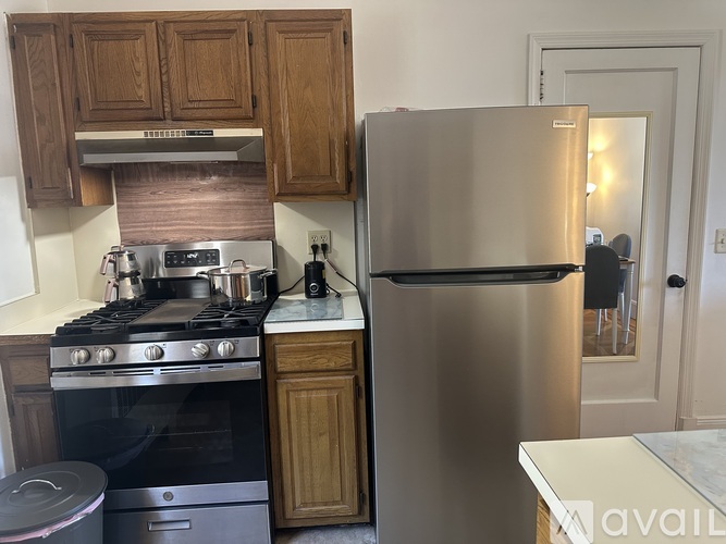 A kitchen with a stove, oven, and refrigerator.