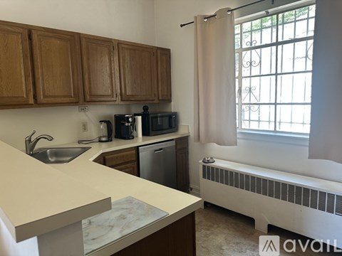 A kitchen with wooden cabinets and a white countertop.