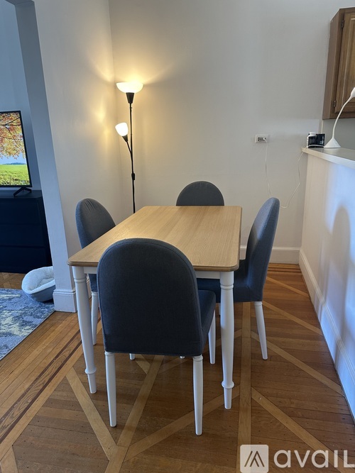 A dining room with a table and chairs.