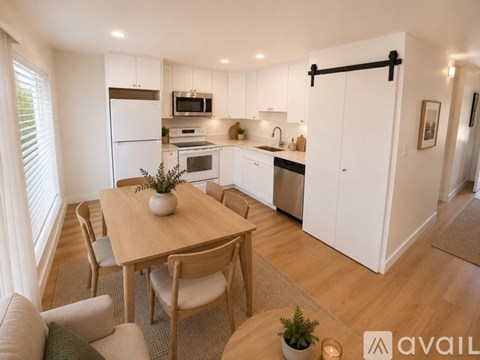 A modern kitchen with a dining table and chairs.