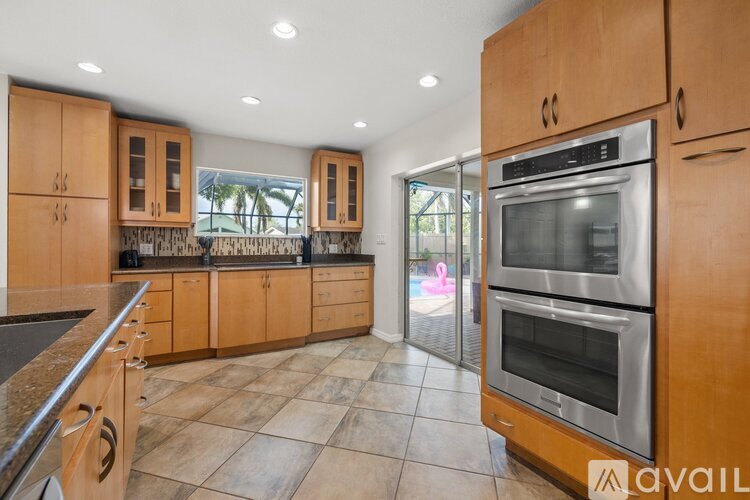 A kitchen with wooden cabinets and a large island.