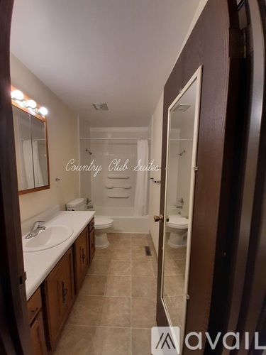 A bathroom with a sink, toilet, and bathtub.