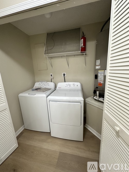 A small laundry room with a washer and dryer.