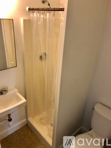 A bathroom with a white toilet and a white sink.