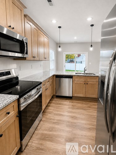 A kitchen with wooden cabinets and stainless steel appliances.