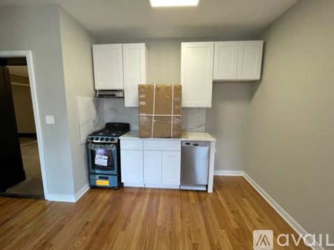 A kitchen area with a dishwasher, oven, and cabinets under construction.
