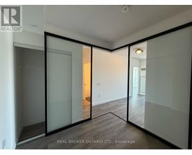 A room with a sliding glass door and a wooden floor.