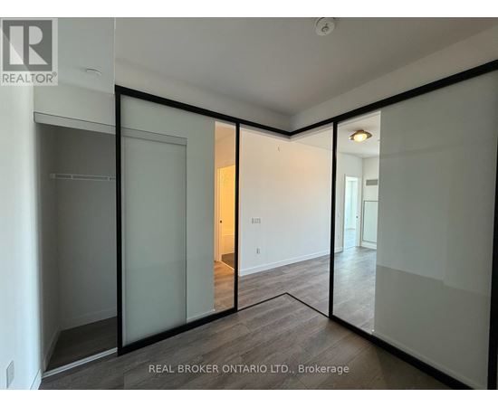 A room with a sliding glass door and a wooden floor.