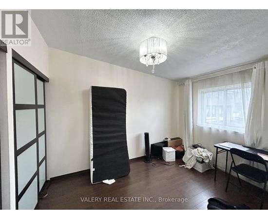 A room with a blackboard leaning against the wall.