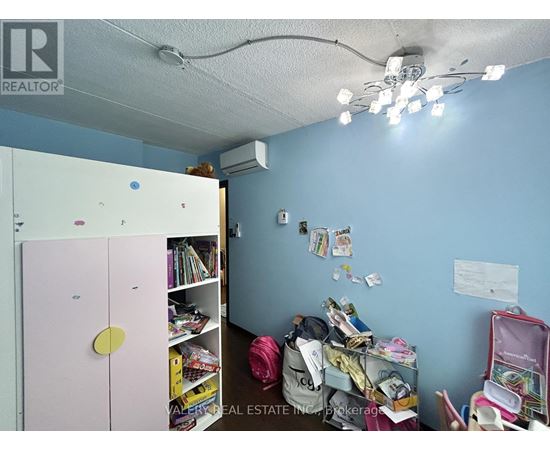 A room with a pink door and a lot of items scattered around.