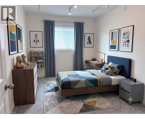 A bedroom with a bed, nightstand, and a dresser with a teddy bear on top.