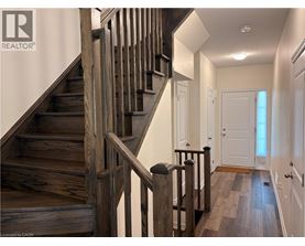 A wooden staircase with a metal railing.