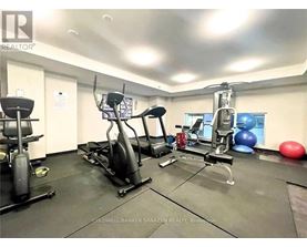 A gym with a variety of equipment including a treadmill, exercise ball, and weight machine.
