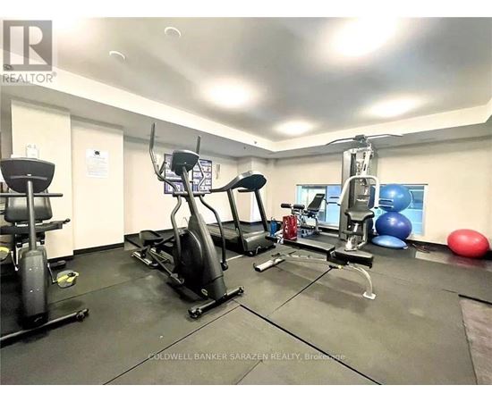 A gym with a variety of equipment including a treadmill, exercise ball, and weight machine.