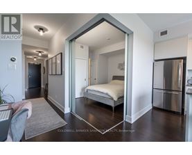 A bedroom with a bed, dresser, and mirror.