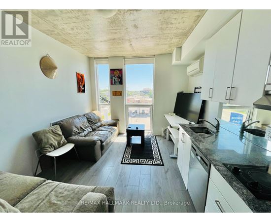 A living room with a couch, chair, and a television.