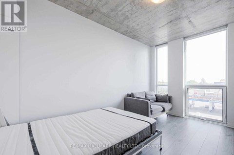 A bedroom with a large bed and a view of the outside.