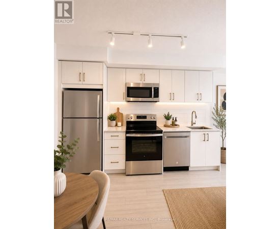 A modern kitchen with white cabinets and stainless steel appliances.