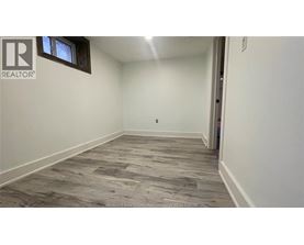 A room with a wooden floor and a window.