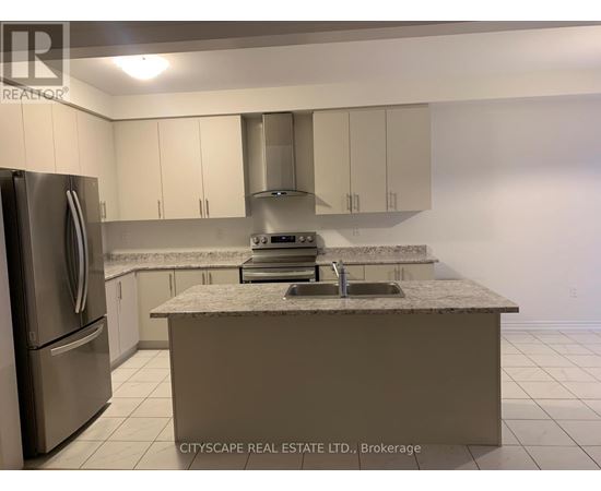 A kitchen with a marble countertop and stainless steel appliances.