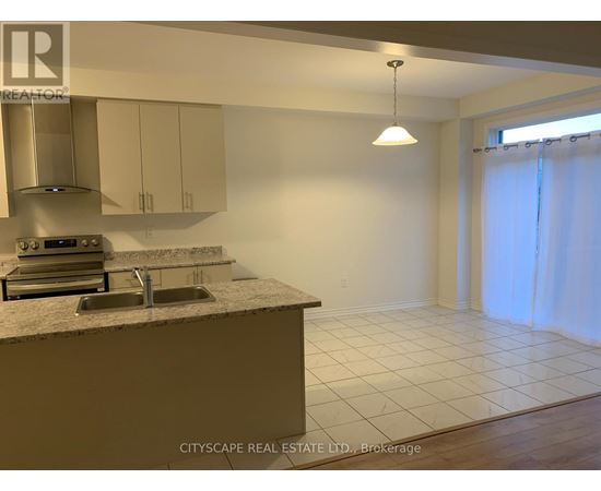 A kitchen with a sink and a stove top oven.