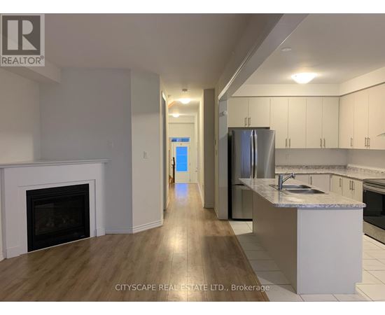 A kitchen with a fireplace and a refrigerator.