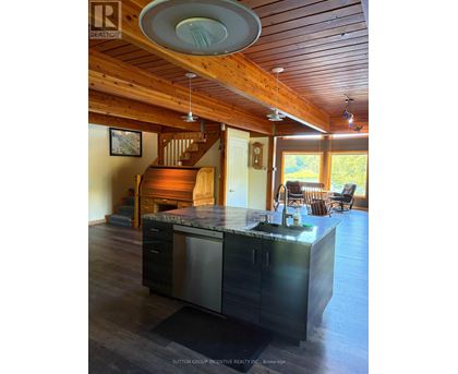 A kitchen with a wooden ceiling and a marble counter top.