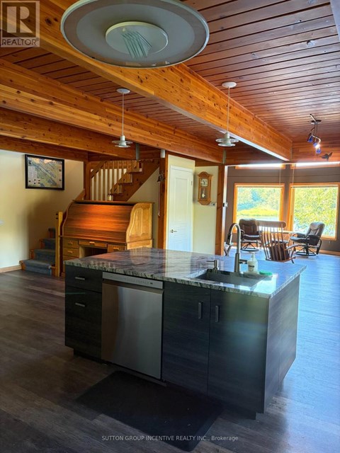A kitchen with a wooden ceiling and a marble counter top.
