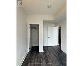 A room with a white door and a black floor.
