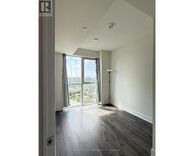 A room with a view of the city through the window.