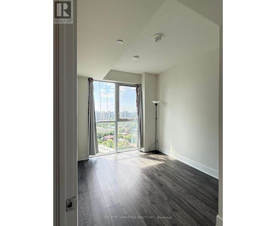 A room with a view of the city through the window.