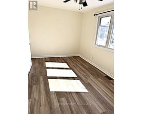 A room with a window and a ceiling fan.