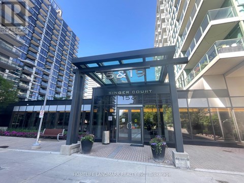 The entrance to a building with a glass door and a sign that reads "SINGER LOCK".