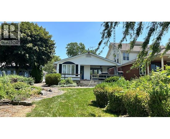 A house with a sign that says REALTOR in front of it.