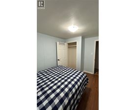 A bedroom with a bed and a door.