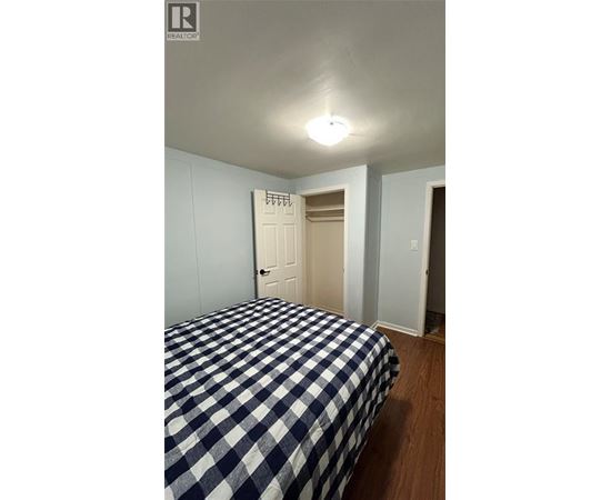 A bedroom with a bed and a door.