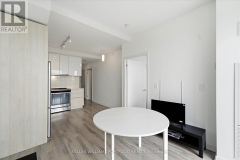 A modern living room with a white table and a television.