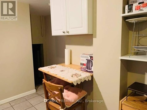 A small kitchen with a table and a chair.