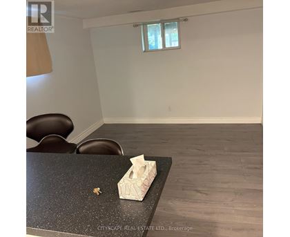 A room with a table and chairs and a window.