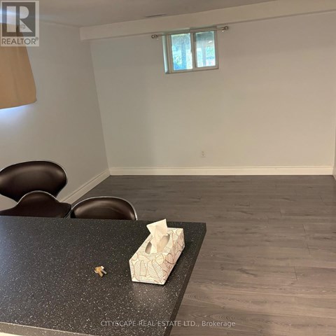 A room with a table and chairs and a window.