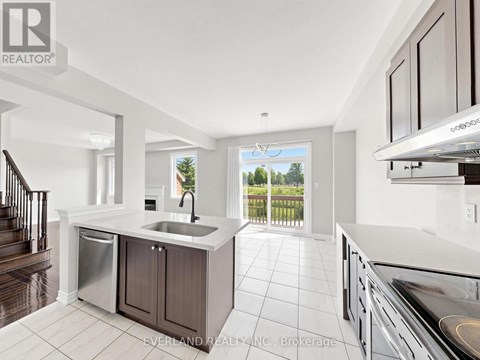 A modern kitchen with a sink and stove top oven.