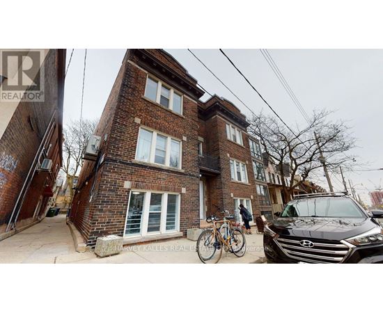 A brick house with a bicycle leaning against it.