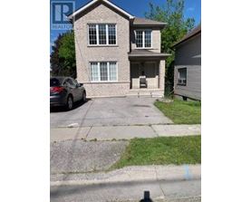 A house with a car parked in front of it.