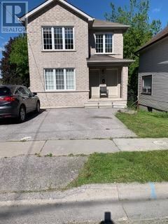 A house with a car parked in front of it.