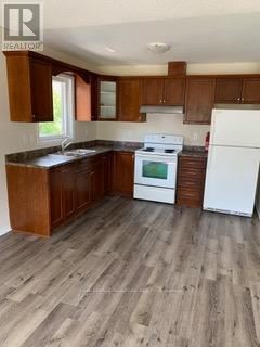 A kitchen with wooden cabinets and a white fridge.