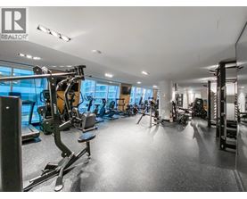 A gym with a variety of equipment including treadmills, weights, and exercise machines.