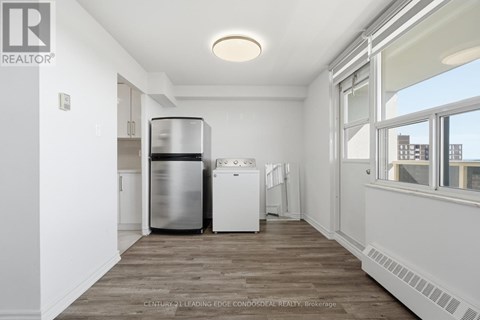 A kitchen with a stainless steel dishwasher and a white dishwasher.