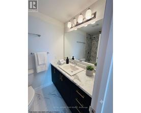 A bathroom with a marble floor and a white sink.